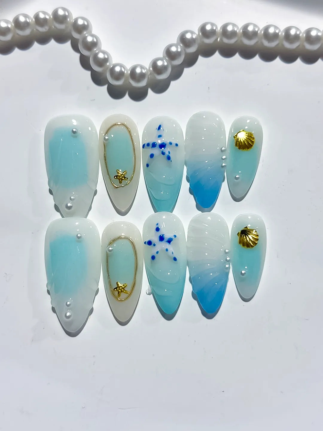 D438 - Medium White Blue Almond Ombre Star Shell