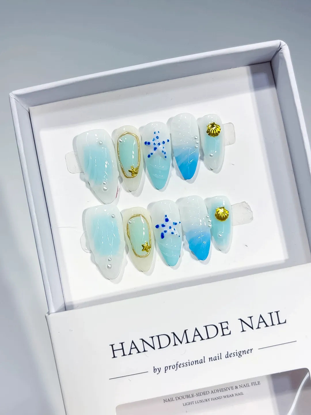 D438 - Medium White Blue Almond Ombre Star Shell