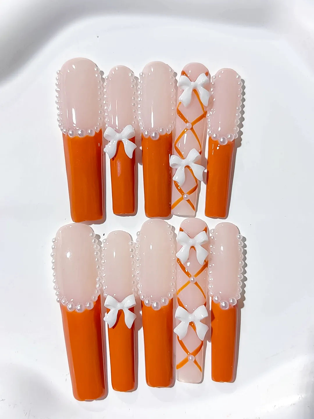 L094 - Long Nude Orange Square French tip Bow Pearl