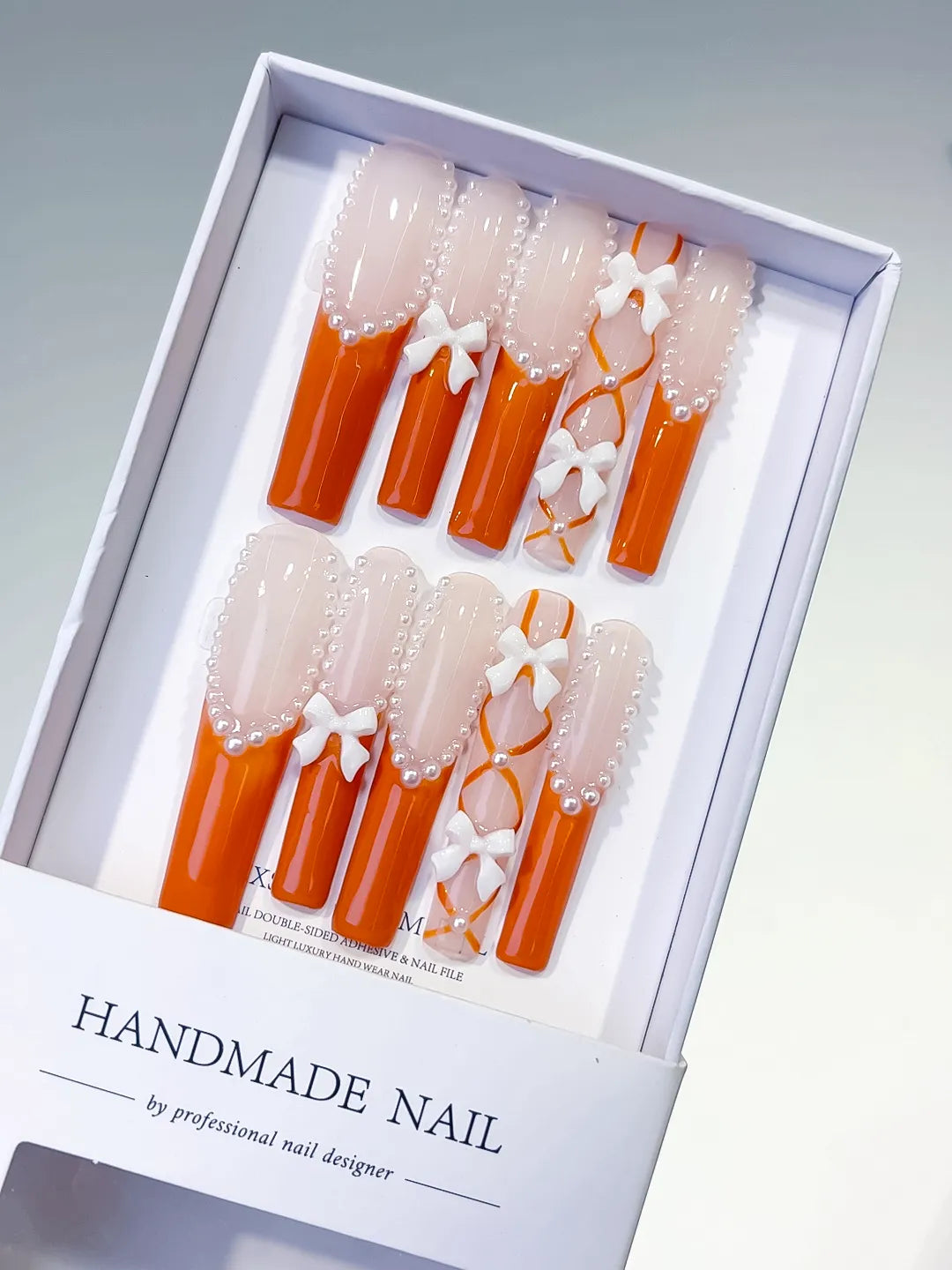 L094 - Long Nude Orange Square French tip Bow Pearl