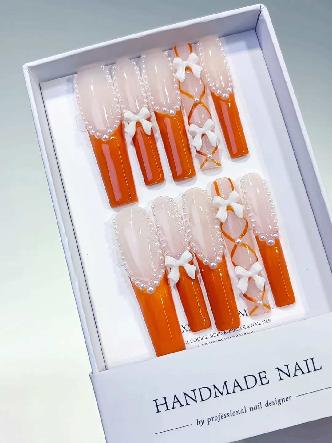 L094 - Long Nude Orange Square French tip Bow Pearl