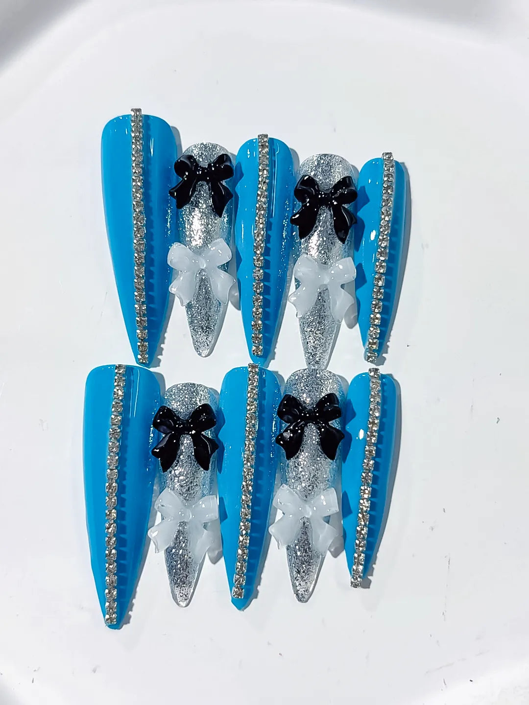 L146 - Long Blue Silver Stiletto Abstract Bow Glitter