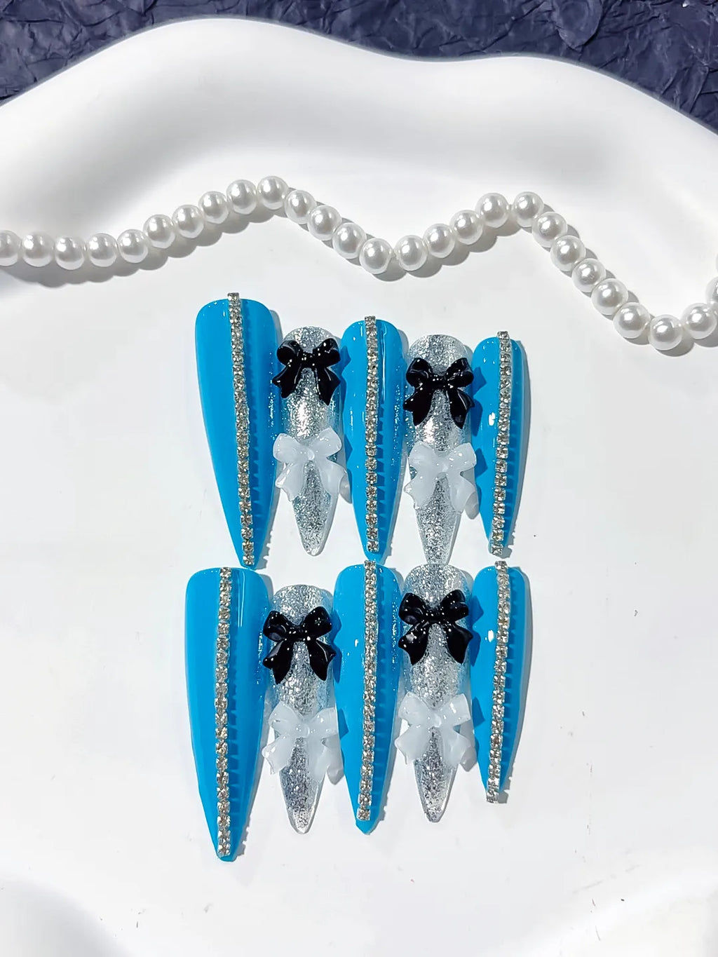 L146 - Long Blue Silver Stiletto Abstract Bow Glitter