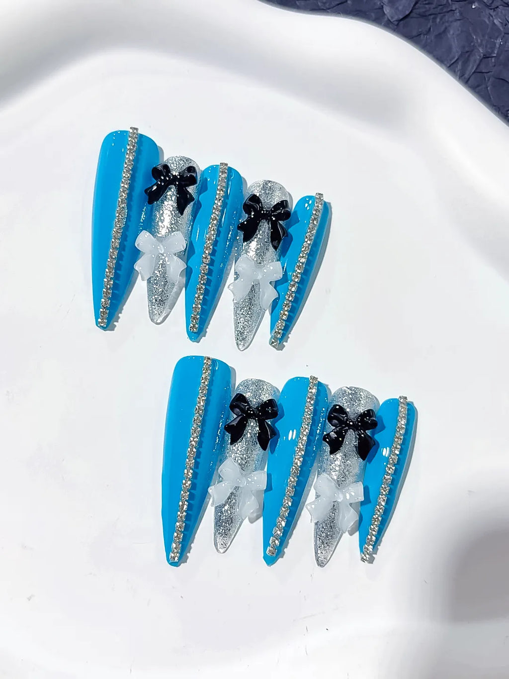 L146 - Long Blue Silver Stiletto Abstract Bow Glitter