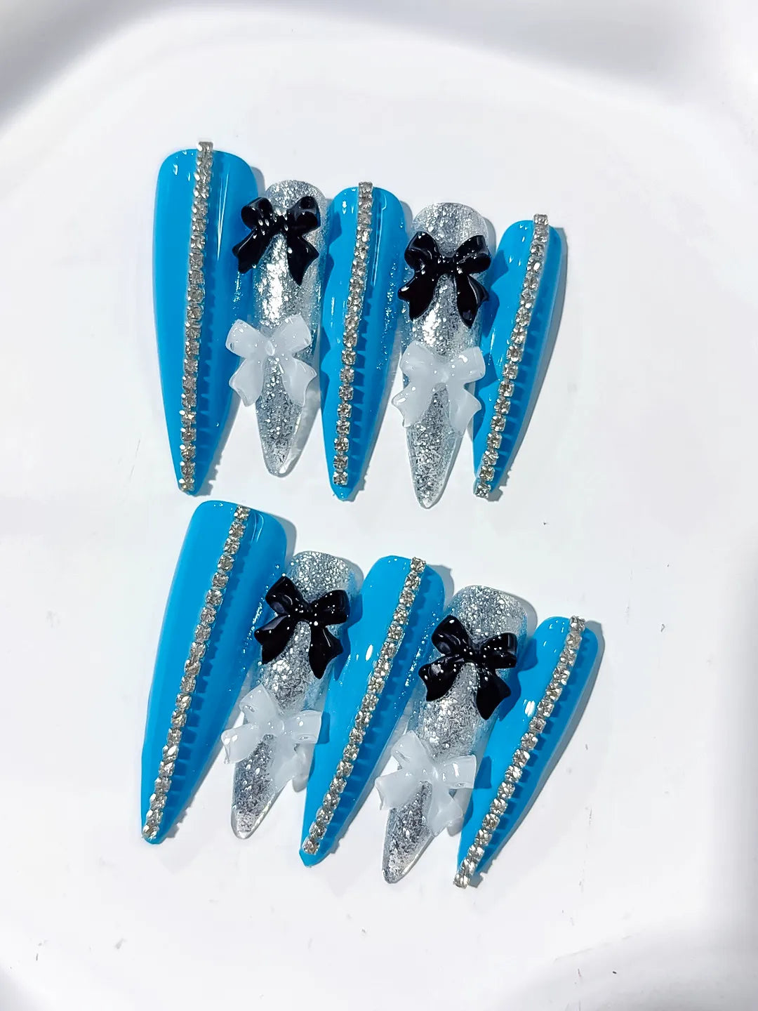 L146 - Long Blue Silver Stiletto Abstract Bow Glitter