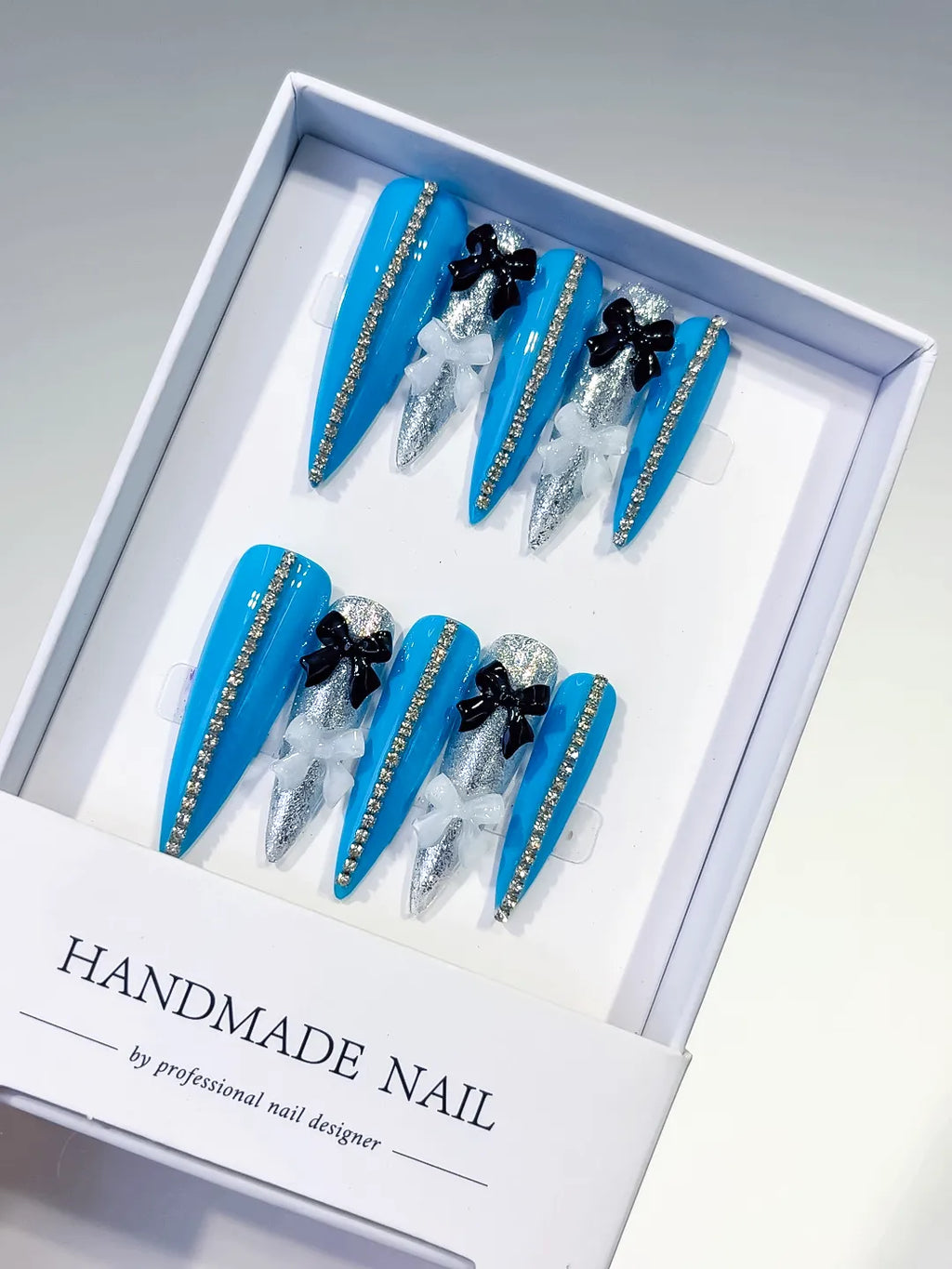 L146 - Long Blue Silver Stiletto Abstract Bow Glitter