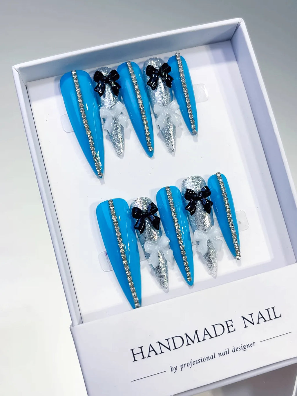 L146 - Long Blue Silver Stiletto Abstract Bow Glitter