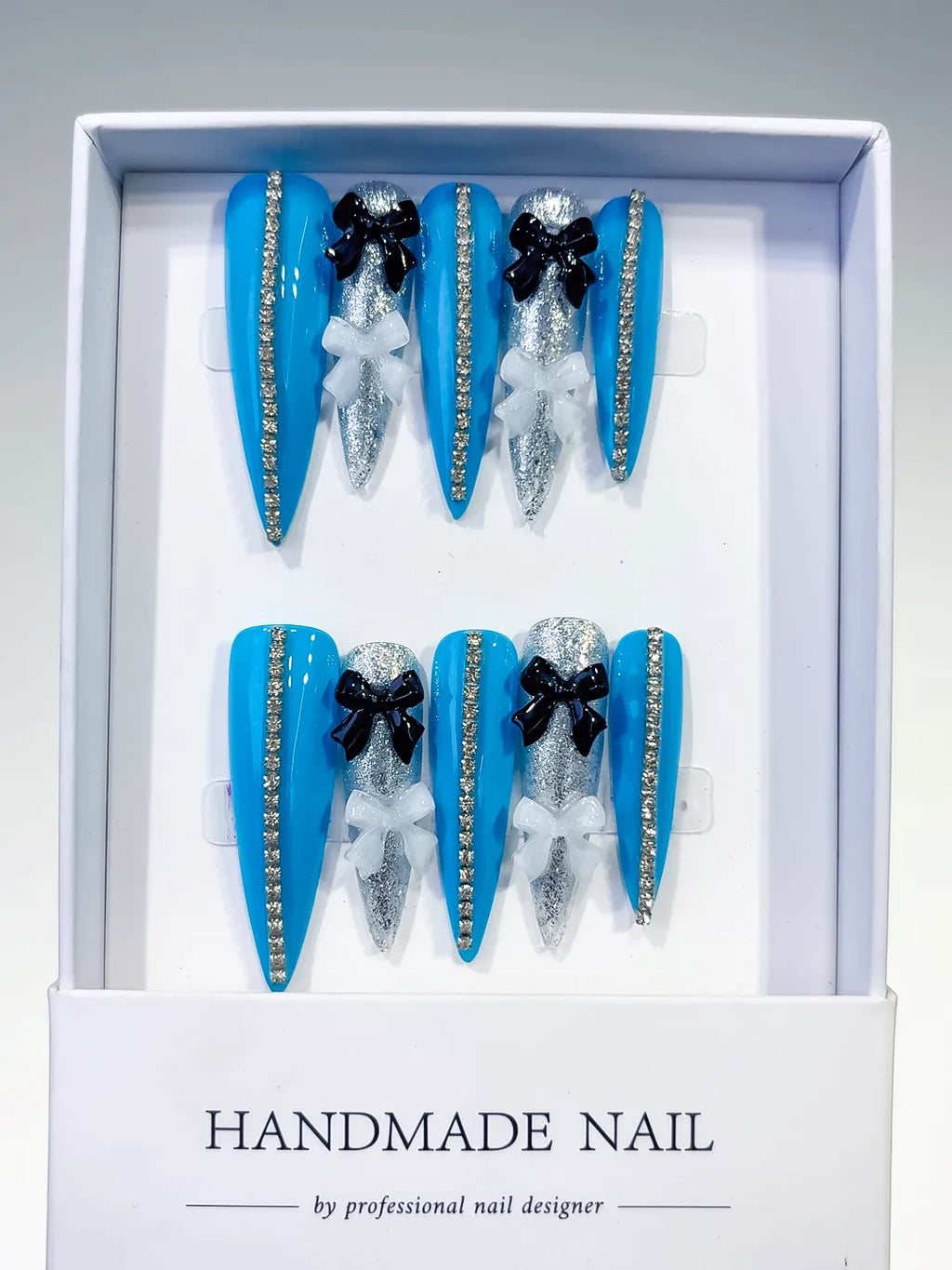 L146 - Long Blue Silver Stiletto Abstract Bow Glitter