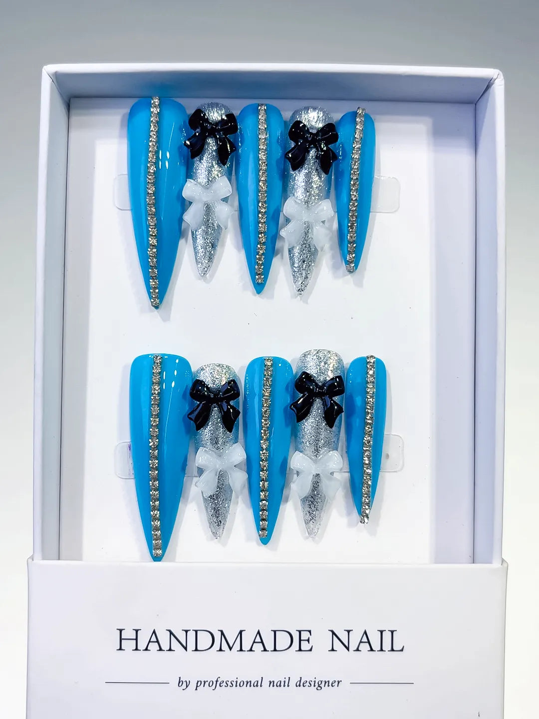 L146 - Long Blue Silver Stiletto Abstract Bow Glitter
