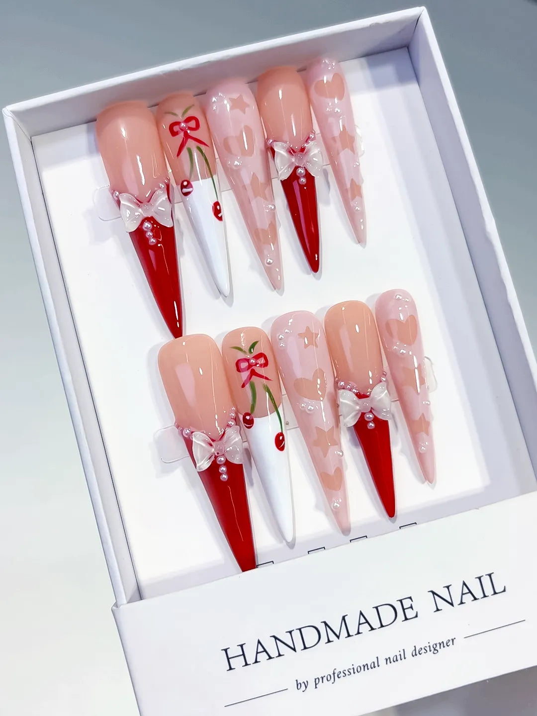 L153 - Long Nude Red Stiletto Abstract Cherry Bow