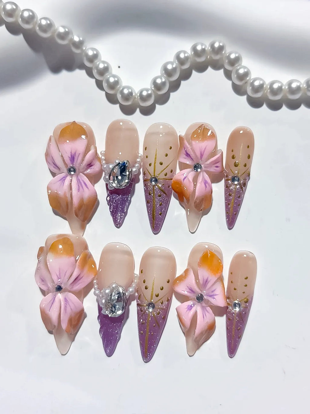 M117 - Long Nude Pink Stiletto Abstract Flower Rhinestone