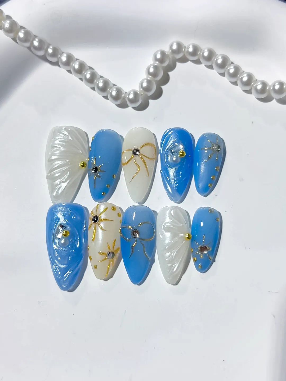 D357 - Medium Blue White Almond Holographic Shell Bow