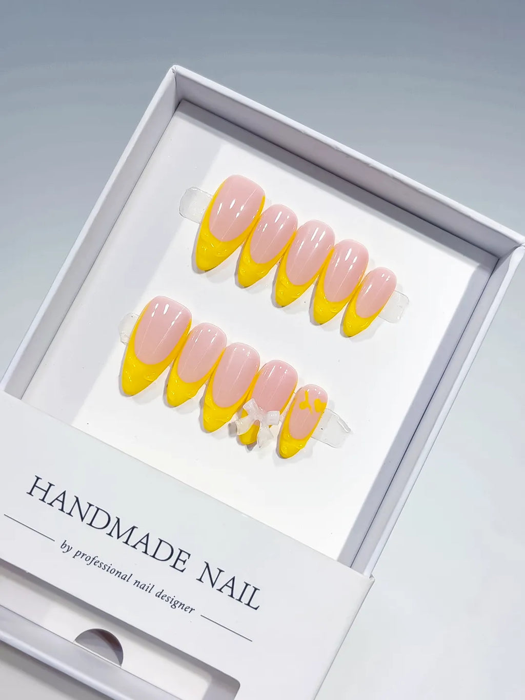 B117 - Medium Nude Yellow Almond French tip Bow
