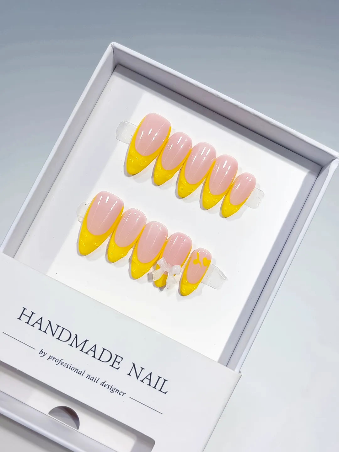 B117 - Medium Nude Yellow Almond French tip Bow