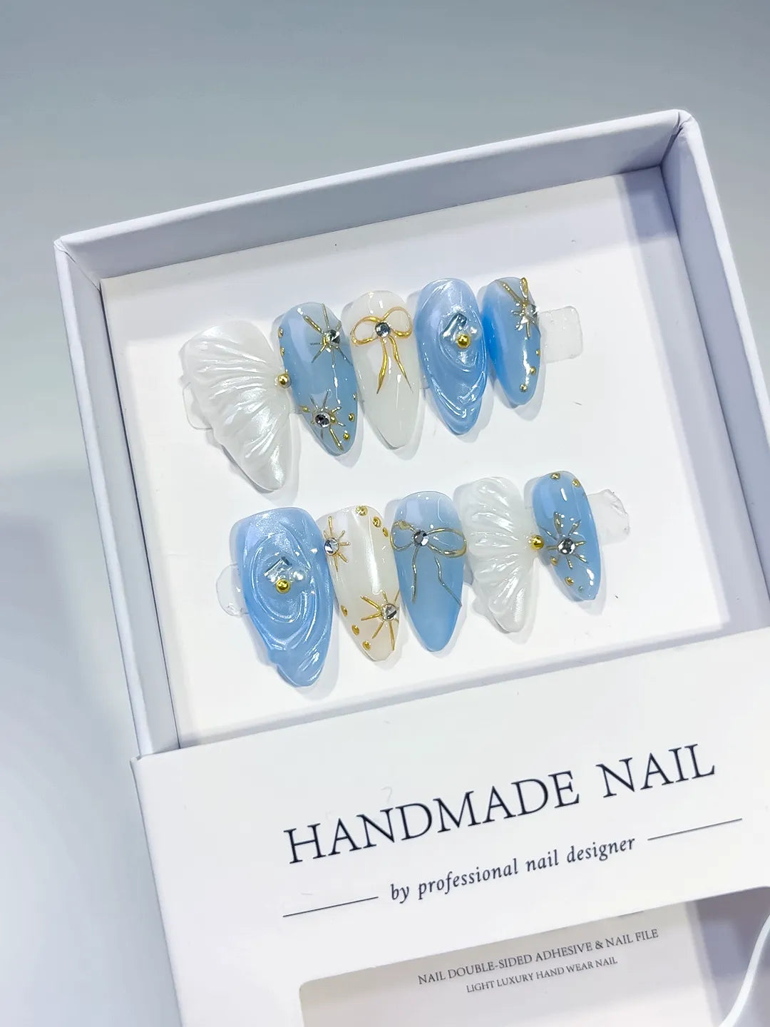 D357 - Medium Blue White Almond Holographic Shell Bow